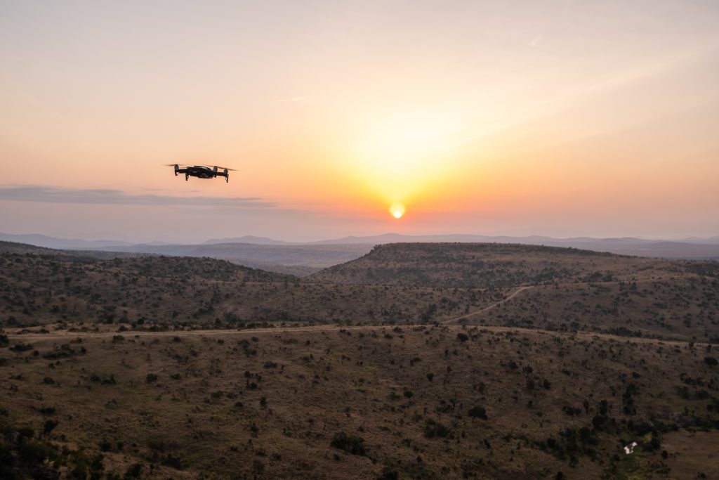 drone flying over the hills with the beautiful sunset in the background in kenya, nairobi, samburu
